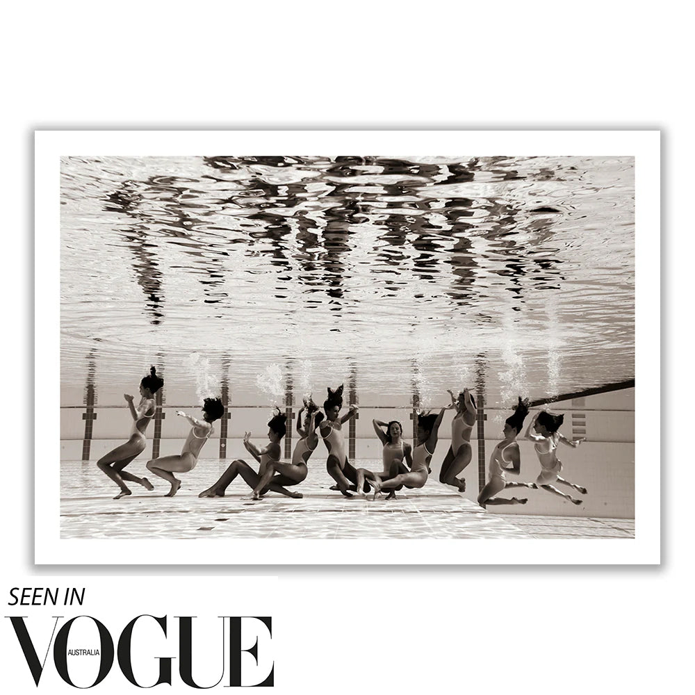 The image titled "Ladies in Waiting #5" by Francesca Owen captures a group of people underwater in a synchronized swimming pose, viewed from beneath, in striking black and white. This artwork is part of a Limited Edition collection and is printed on Giclee fine art paper. The text at the bottom reads "Seen in Vogue Australia.