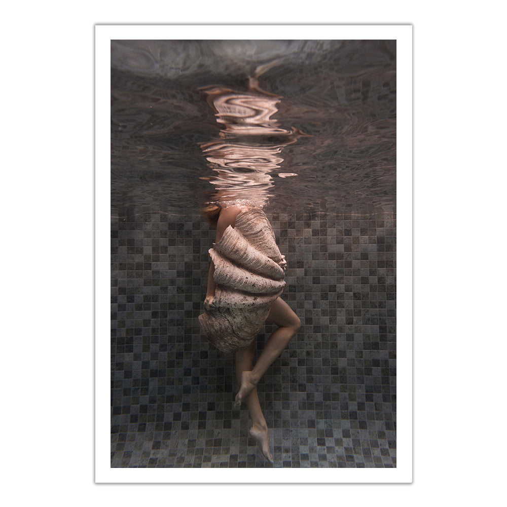 A person underwater, encased in a large seashell amid soft ripples and tiled pool walls, features in "Shell & She #3"—a fine art print by Francesca Owen that includes a certificate of authenticity.
