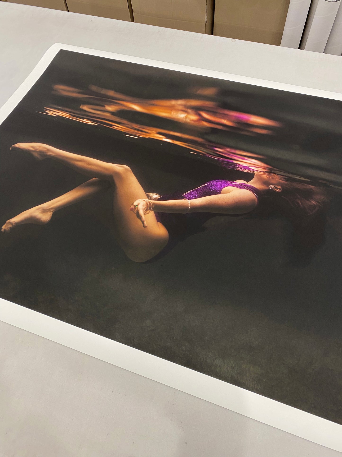 Show Time Part 2, #2" by Francesca Owen captures a woman in a purple swimsuit floating underwater, her reflection above. Fine art prints come with a certificate of authenticity.