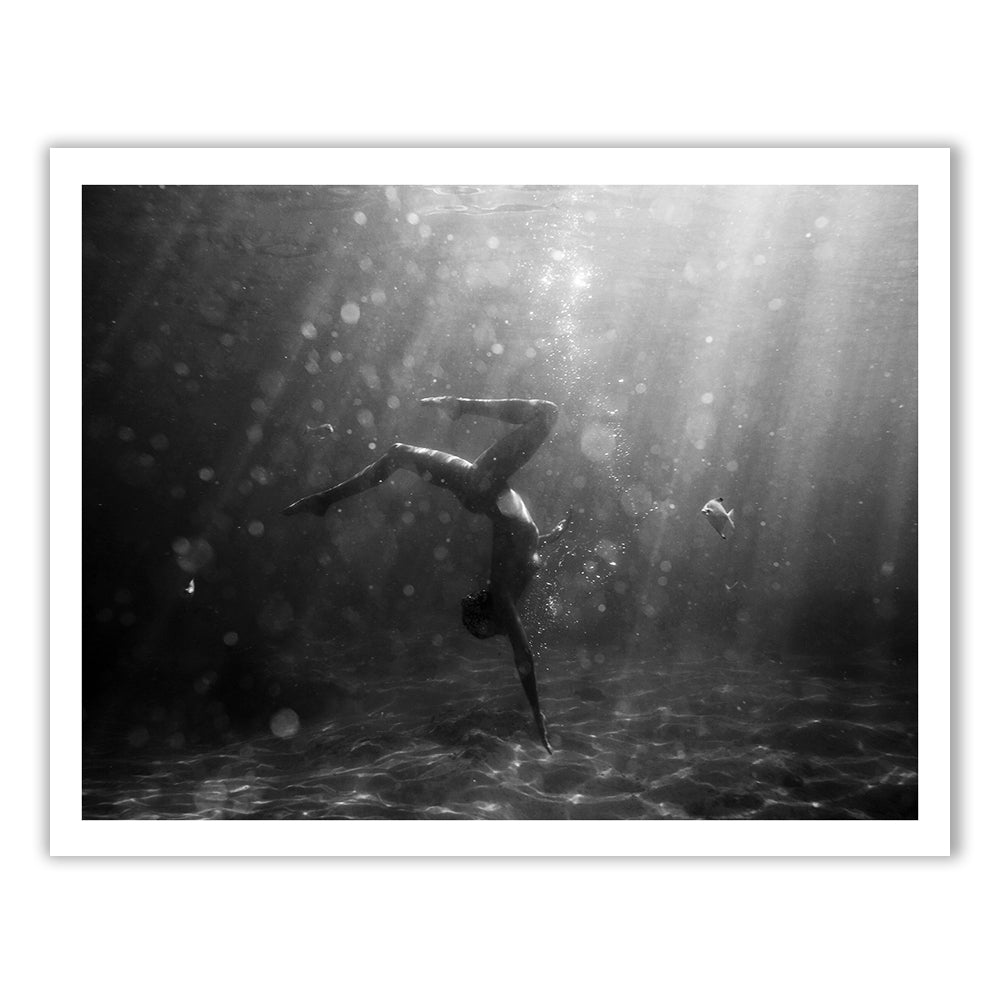 Still Waters #3 by Francesca Owen is a black and white underwater photo of a person arching in a backbend amid bubbles and sunlight. Printed on fine art paper, it includes a certificate of authenticity.