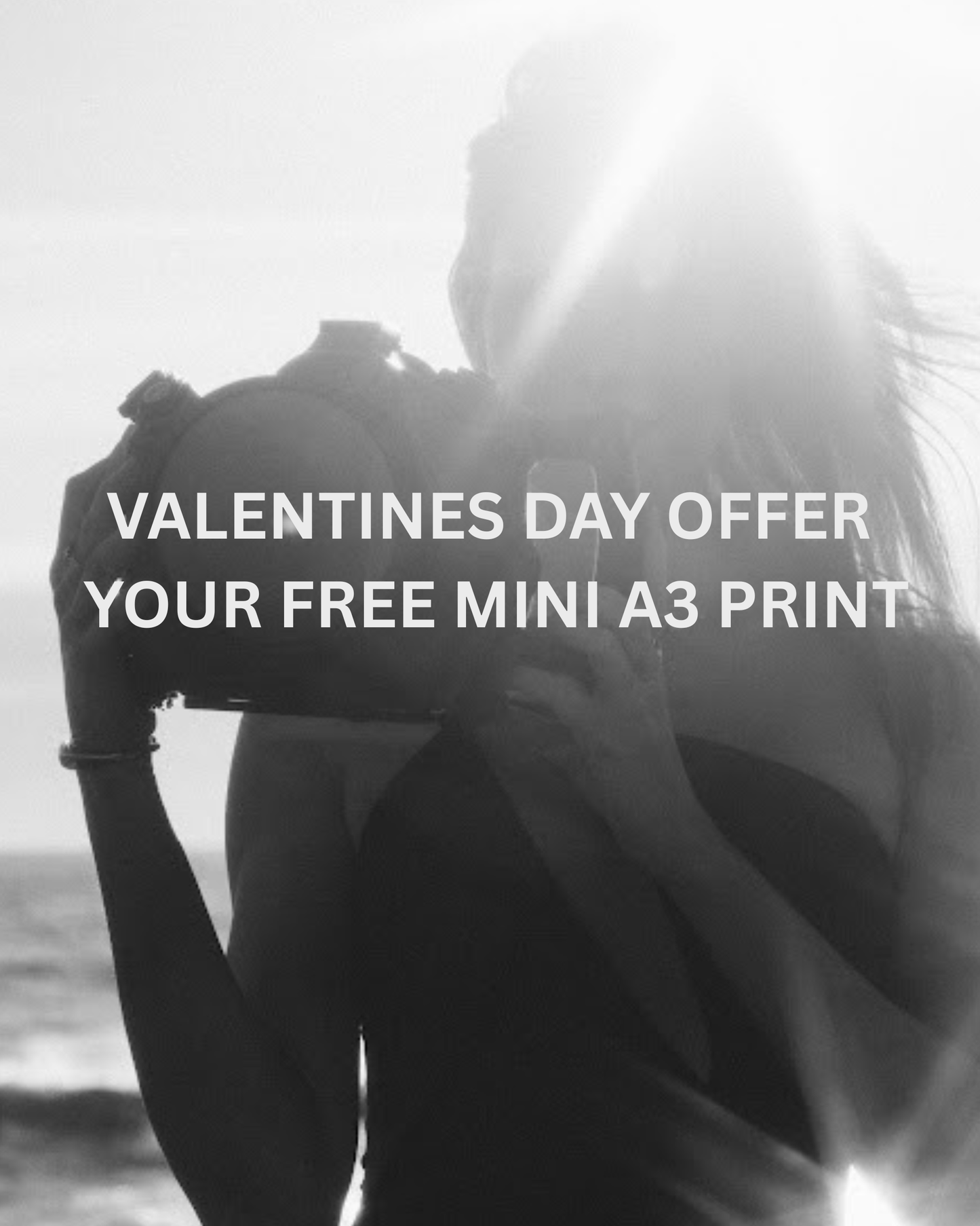 A woman with a vintage camera by the seaside, sunlight streaming behind her. Text: "Francesca Owen - Free Mini A3 Print with Purchase." The perfect thank you gift for our followers this Valentine’s Day!.
