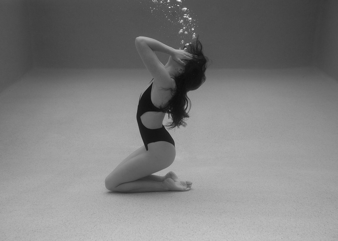 Self Reflection #12" by Francesca Owen depicts a woman in a bathing suit underwater—available as a fine art print with a certificate of authenticity.
