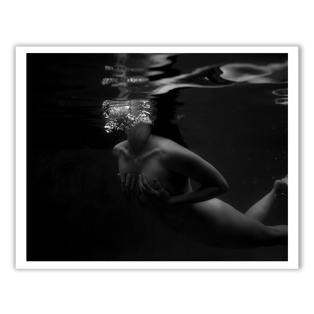 Hold On," a black-and-white photograph by Francesca Owen, captures a person submerged underwater with bubbles rising from their face. Unclothed and partially hidden in shadow, they hold their chest with both hands. The high-contrast image has an artistic, surreal quality and is available on fine art paper, hand-signed by the artist.