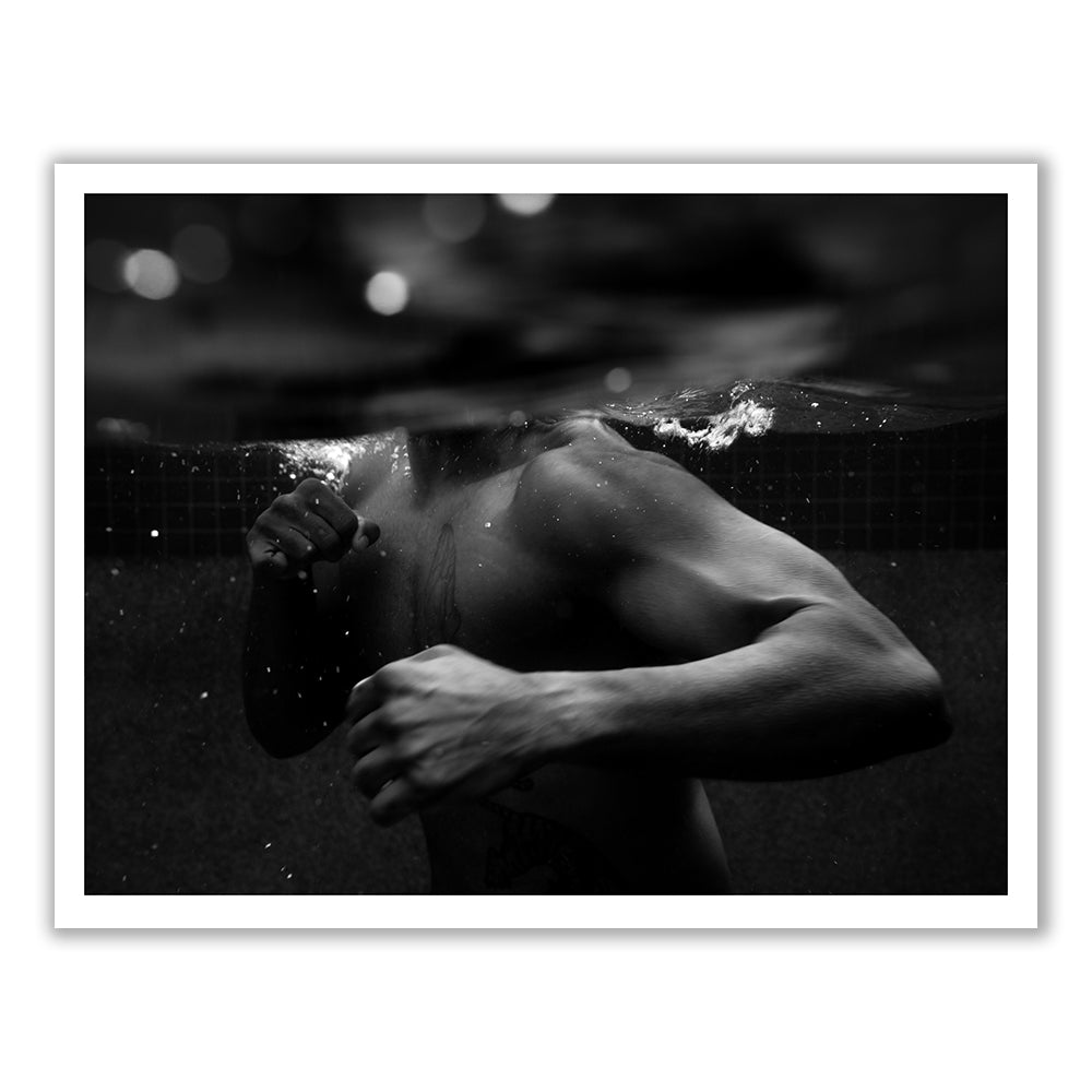 New Waters #1 by Francesca Owen features a hand-signed black and white image of a person partially submerged in water, throwing a punch with their right arm. The water creates a split effect, showing the person's upper body both above and below the surface. This striking image is printed with archival pigments on fine art paper, highlighting muscular arms and a dynamic pose.