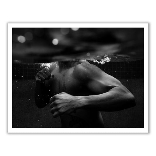 New Waters #1 by Francesca Owen features a hand-signed black and white image of a person partially submerged in water, throwing a punch with their right arm. The water creates a split effect, showing the person's upper body both above and below the surface. This striking image is printed with archival pigments on fine art paper, highlighting muscular arms and a dynamic pose.