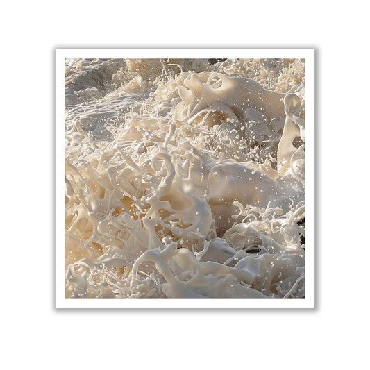 Wild Seas Part I, V 2 — Limited Edition Print by Francesca Owen features a close-up photograph of ocean foam in mid-motion. The intricate swirling patterns and bubbles create a dynamic and abstract texture, framed elegantly by a white border. Printed on fine art paper, this limited edition piece captures the energy and movement of the sea beautifully.