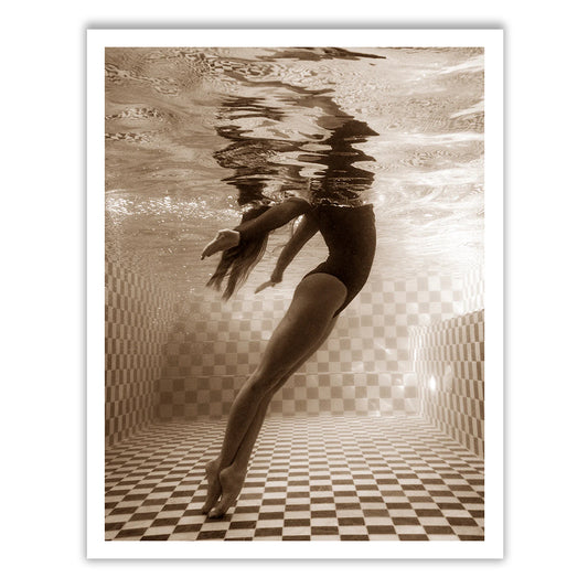 Wild at Heart no.2" by Francesca Owen is a sepia-toned photo of a person underwater in a swimming pool, framed with a white border. The person is in a streamlined position, with arms extended and toes pointed, swimming near the tiled pool floor and surface. The water creates rippling reflections above. This piece is available as fine art prints using archival pigments, each one hand signed by the artist.