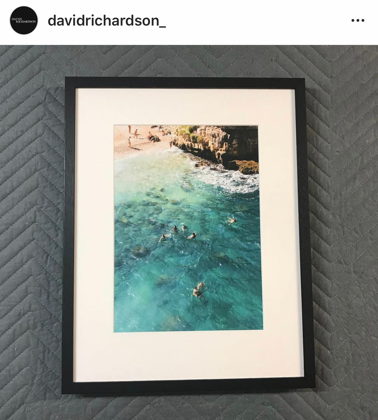Three framed photographs hang on a gray wall. The left photo, by Francesca Owen, shows a person skateboarding in black and white. The top right photo is black and white, depicting a person swimming underwater. The bottom right photo shows "A Polignano a Mare," capturing a vibrant beach scene with swimmers in the ocean—all fine art prints using archival pigments.