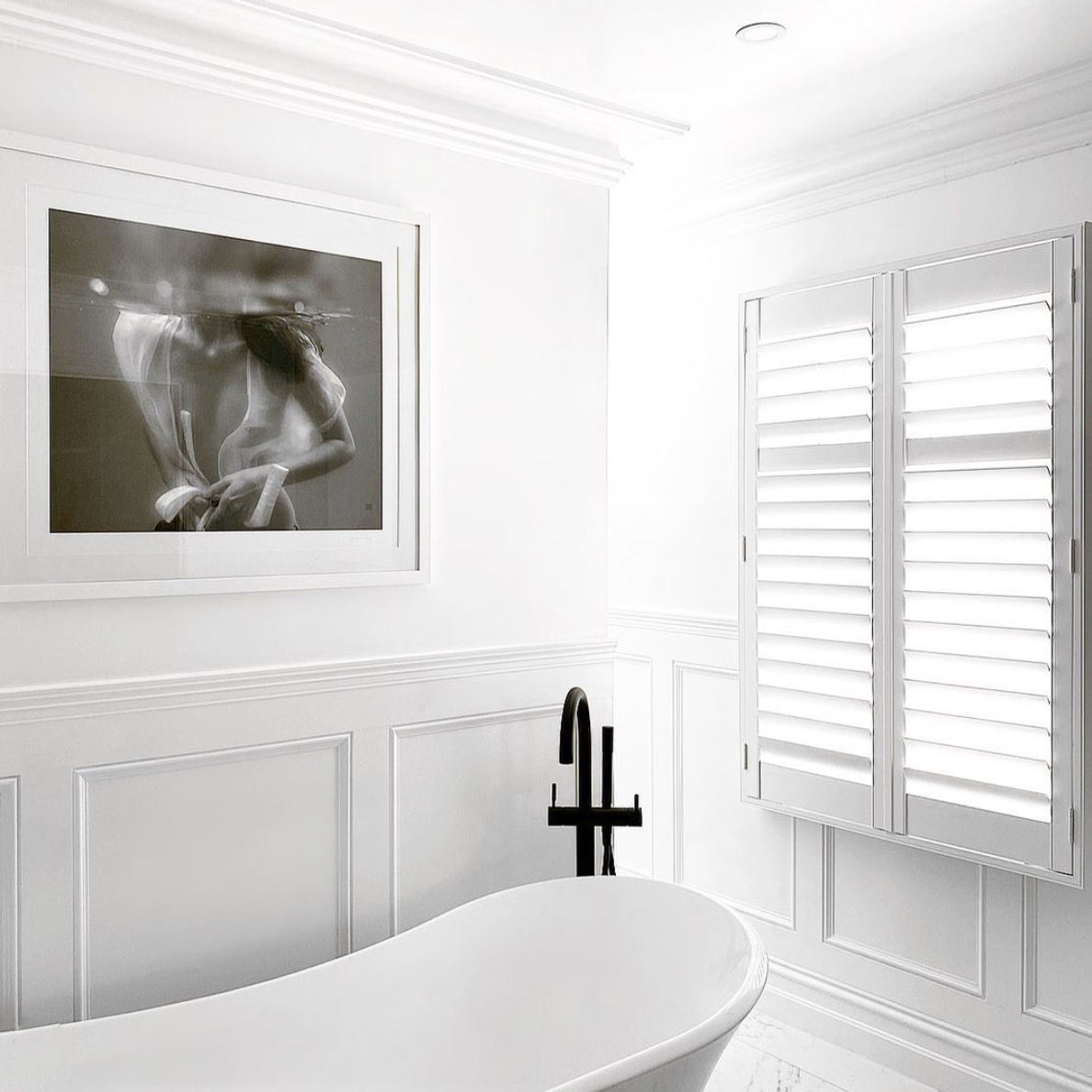 The intriguing black and white underwater photograph, titled "Softness #1 B&W" by Francesca Owen, captures a person partially submerged in water wearing an unbuttoned, translucent white shirt. With their head above the water's surface and their torso and hands below, the image creates an ethereal and serene atmosphere ideal for fine art prints or custom framing.